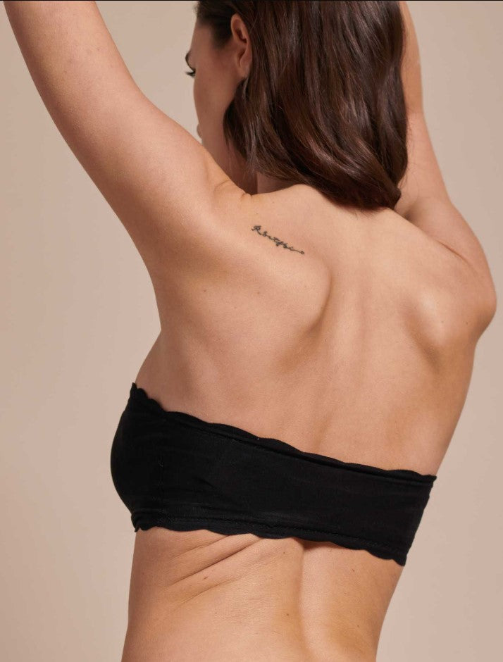 Women wearing a EGi Laser Cut Cotton Bandeau, crafted in Italy, that boasts a sleek fabric design and enhanced flexibility, showing the back.