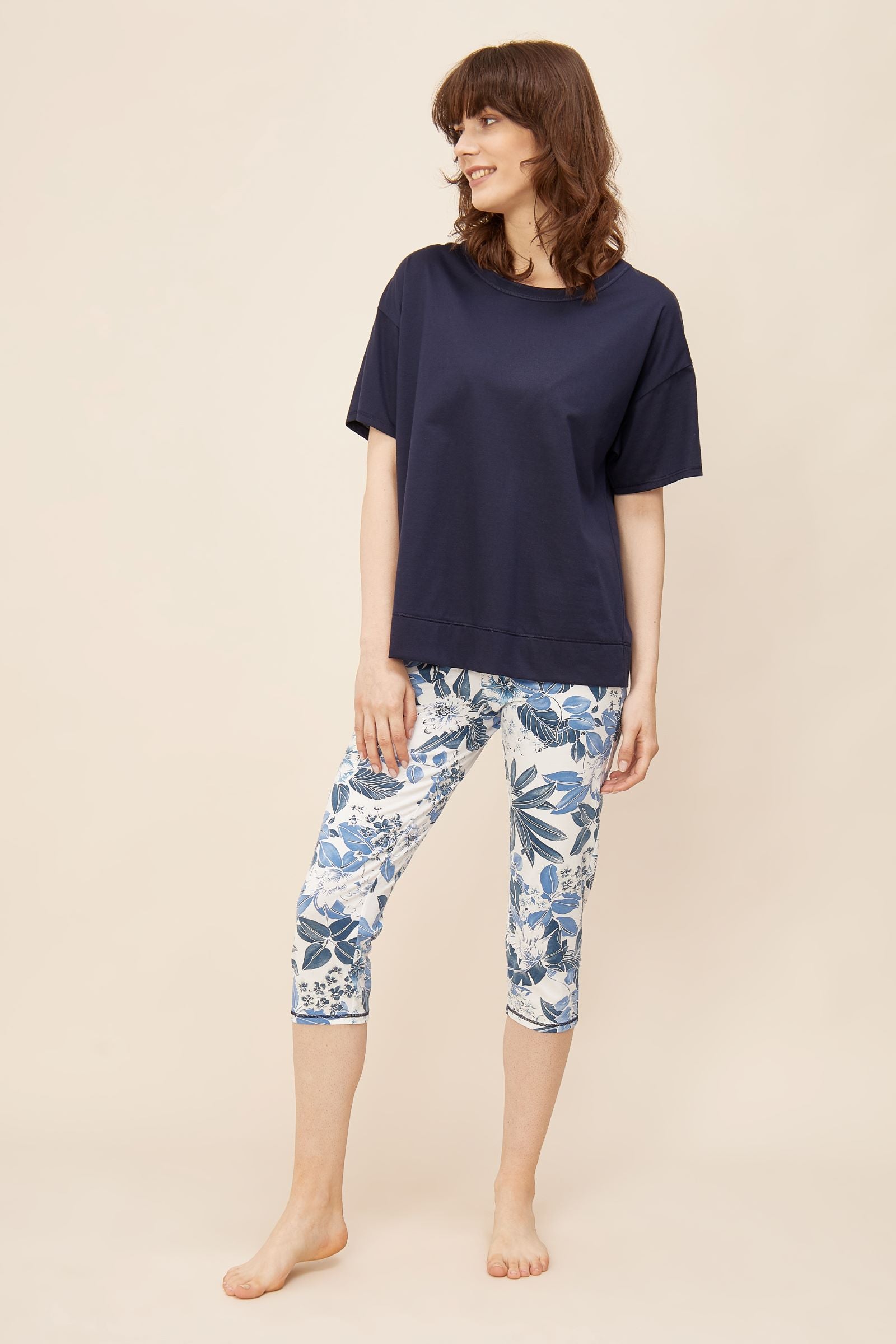 This two-piece pajama set from Rösch's Smart Casual collection is crafted from lightweight, supple single jersey cotton fabric, boasting a solid colored top and capri pants embellished with an indigo floral print.  Short sleeve  Wide crew-neck